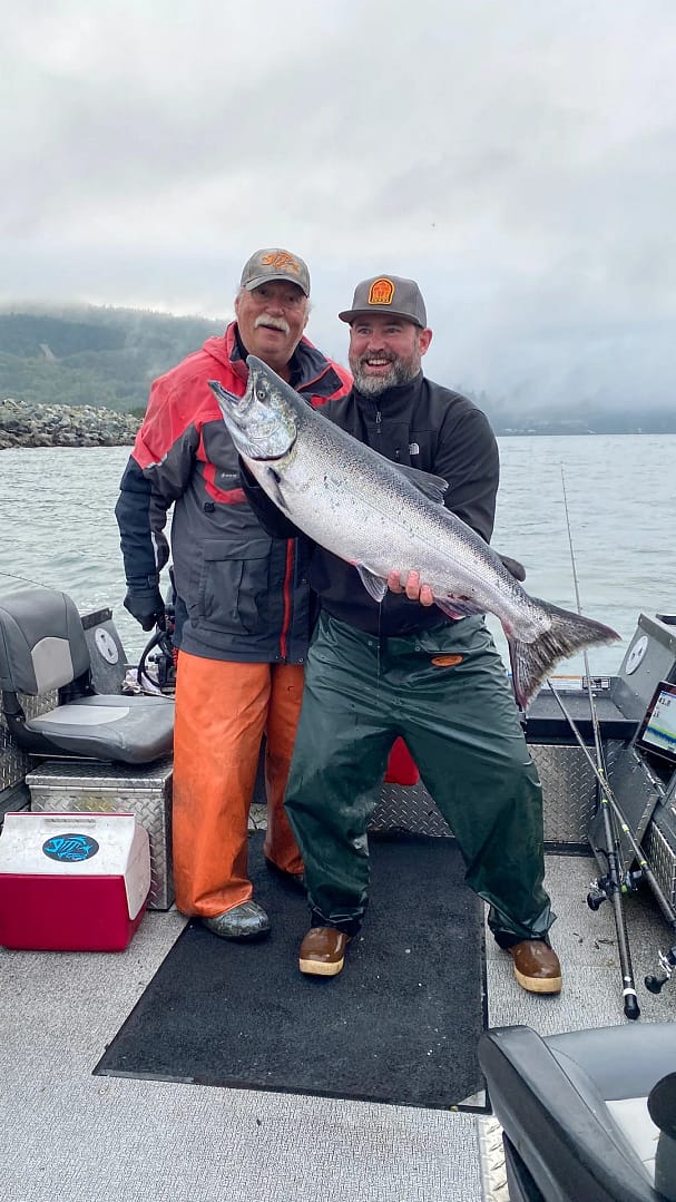 Terry and a client holding up a large salmon